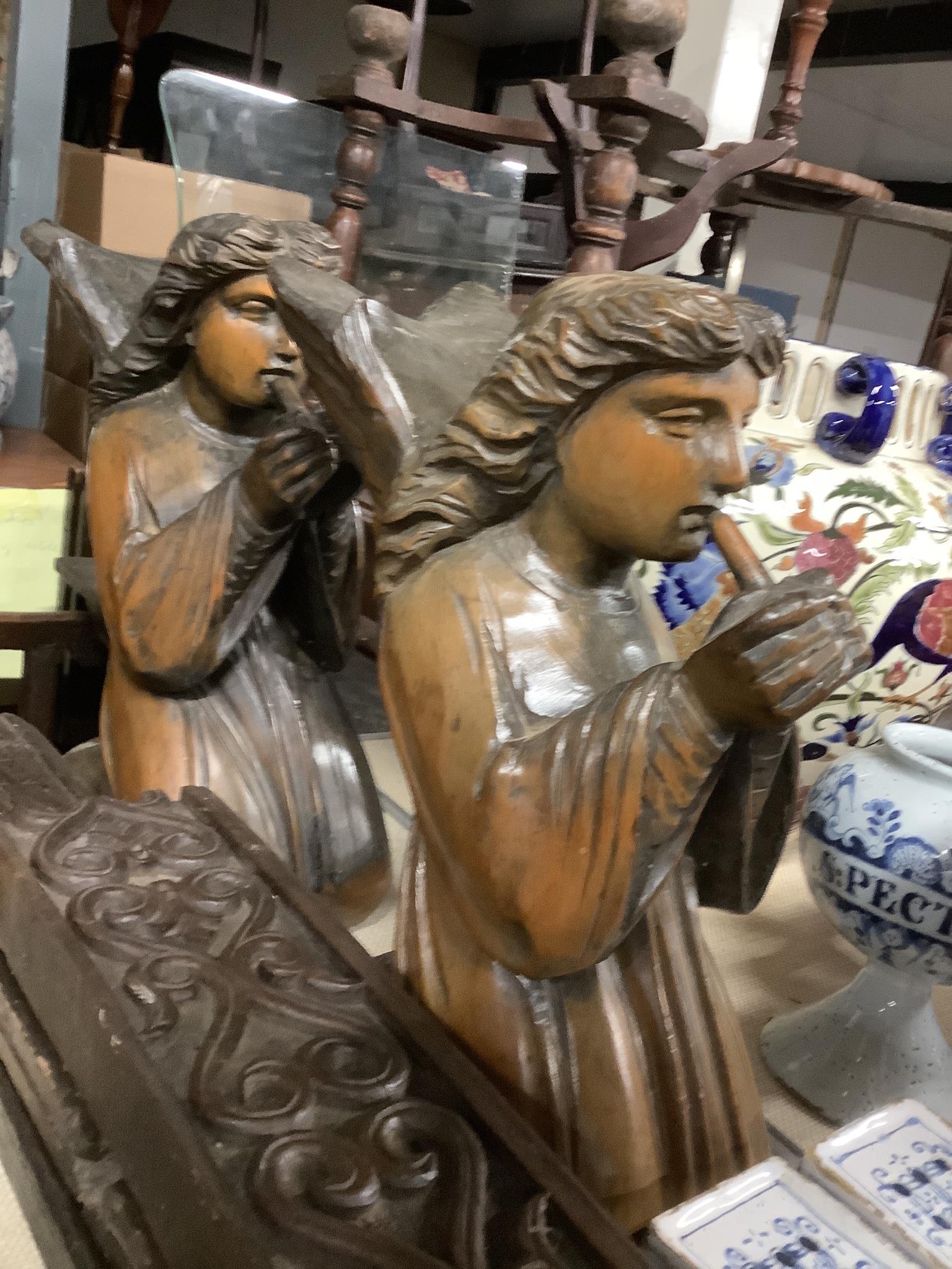 A pair of carved pine angels playing recorders, height 40cm